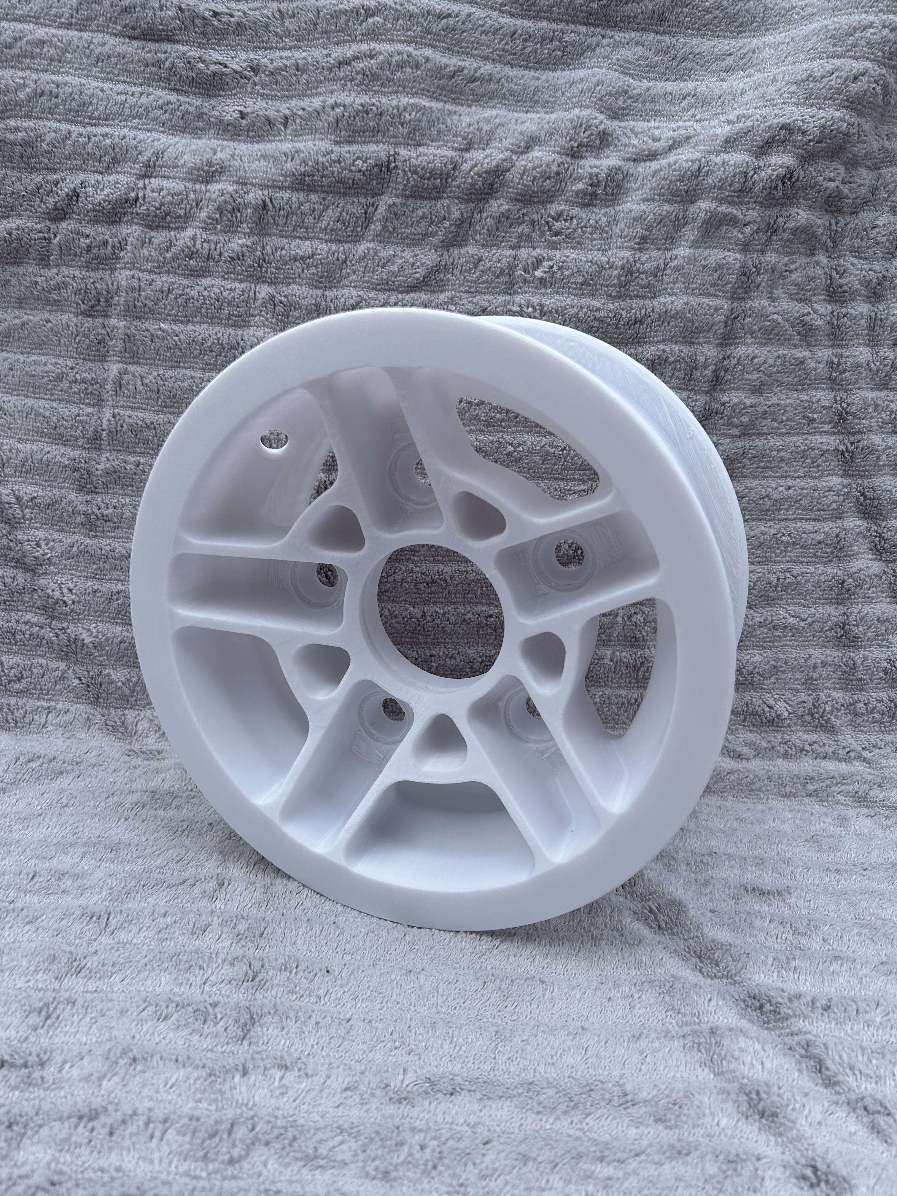 White 3D printed wheel prototype demonstrating Goin Design’s rapid prototyping and custom part design capabilities.